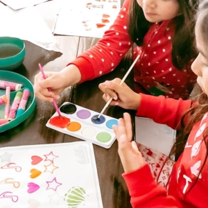 two students painting with watercolors